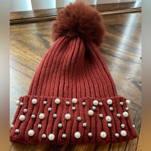 Burnt orange / brown hat with Pom Pom top.